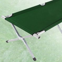 a green table that is sitting on the ground with two legs and one leg extended