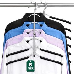 there are six shirts hanging on the clothes hanger and one is blue, pink, white and black