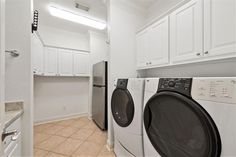 a washer and dryer in a white laundry room