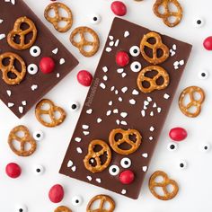 two chocolate bars decorated with pretzels and cherries