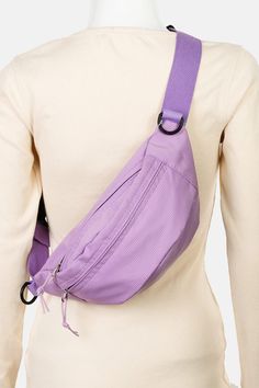 a woman wearing a purple fanny bag on her back with an adjustable belt around the waist