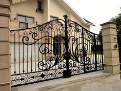 a wrought iron gate in front of a house