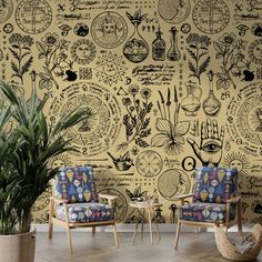 two chairs sitting next to each other in front of a wall covered with different types of plants