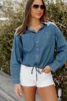 Introducing the DENIM DREAMER CROP TOP, a must-have for any fashion-forward individual. Crafted from high-quality chambray fabric, this crop top features a stylish button front and a versatile drawstring hem. Elevate your wardrobe and achieve a chic look with this trendy piece. Casual Summer Cotton Denim Jacket, Dark Wash Button-up Top For Summer, Summer Casual Washed Blue Denim Jacket, Casual Washed Blue Summer Denim Jacket, Casual Washed Blue Denim Jacket For Summer, Relaxed Fit Denim Top For Day Out, Collared Medium Wash Denim Jacket For Summer, Summer Cropped Cotton Denim Jacket, Dark Wash Cropped Top With Button Closure