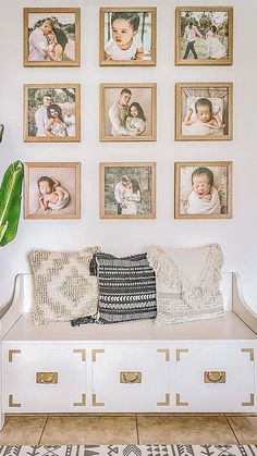 a living room with pictures on the wall and a white bench in front of it