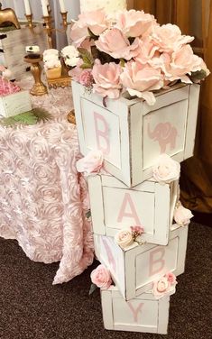 a tall white wooden box with pink flowers on top