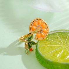 Orange Slices Ring is an adjustable ring with a slice of orange. This is a unique jewelry design from Selenichast. If you need a piece of fine jewelry or like nature jewelry, you can try for this fruit ring is at a reasonable price.?Add a pop of playful color to your look with our Orange Slices Ring! Made with enamel and gold, this eye-catching accessory will make you stand out in any crowd. (Warning: may cause sudden cravings for citrus.) DETAILS Plating: 18K Gold Materials: 18K Gold on Brass, Adjustable Weights, Leaf Ring, 18k Gold Ring, Enamel Ring, Unique Jewelry Designs, Orange Slices, Nature Jewelry, Adjustable Ring, Birthday Gifts For Women