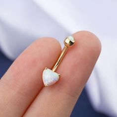 Save 15% Off with Code "GOLD15" Description: Heart Design: You won't miss this opal glitter yellow gold heart prong set belly button ring, which can satisfy you all unique dress-up!This trendy belly button piercing features a glitter heart shape white opal on the bottom and a small rounded opal gem on the top. It is Lightweight, comfortable, and easy to insert and screw the top ball. Safe Material: Made of 14KT real gold, good for sensitive skin, even can be used as the first piercing belly ring Aesthetic Belly Button Piercing Gold, Cute Gold Belly Button Piercing, Pretty Belly Button Piercings Gold, Gold Heart Belly Button Piercing, Opal Navel Piercing, Bellybutton Piercings, Gold Locket Necklace, Cool Piercings, Cute Piercings