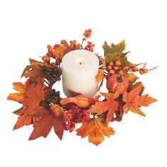 a white candle surrounded by autumn leaves and berries