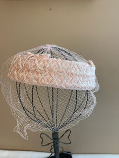 "Pink Wedding Halo Hat with Veil, Women's Birdcage Vintage Fashion Veiled Mini Raffia Hat, MCM Crown Hat, Church Lady Hat Lovely woven raffia outer with pink velvet bow accent. This is a crown or halo hat with a fabric base, woven raffia detail. The netting is in great condition, no tears. It is placed a little longer in the front. Very well made and cared for. No label. Inside circumference: 22\". Made in the age of hats! No label. No obvious defects, tears or holes. Thank you for looking. This Adjustable Cloche Straw Hat For Wedding, Pink Wedding Hat With Structured Crown, Curved Brim Hat With Ribbon For Church, Pink Structured Crown Headpiece For Wedding, Pink Fitted Hat With Structured Crown, Adjustable Pink Straw Hat For Wedding, Church Hat With Ribbon And Curved Brim, Fitted Wedding Hat With Ribbon, Pink Adjustable Straw Hat For Wedding