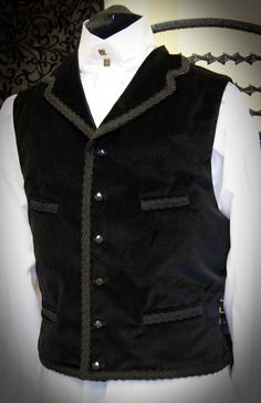 Velvet Dr Who waistcoat with braid trim by Obsidian Gothic, great for 11th Dr cosplay, steampunk or gothic style. Check out the Obsidian Gothic Clothing shop for shirts to go with this style. The waistcoat is made from cotton velvet & is fully lined & backed in satin. There is a full collar and 4 pockets at the front waist & chest. The waistcoat fastens with ornamental buttons (buttons may vary from those shown). Black braid trims the collar, top front, bottom edges & pocket welt Gothic Sleeveless Vest, Steampunk Sleeveless Vest With Buttons, Fitted Steampunk Vest For Cosplay, Gothic Vest For Halloween Costume Party, Gothic Vest For Halloween Cosplay, Gothic Sleeveless Vest For Costume Party, Gothic Fitted Vest With Buttons, Fitted Gothic Vest For Cosplay, Steampunk Vest For Halloween Cosplay