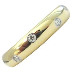 TIFFANY & Co. Etoile 18K Gold Diamond 4mm Band Ring 8.5 Metal: 18K gold Size: 8.5 Band Width: 4mm Diamond: 10 round brilliant diamonds, carat total weight .22 Hallmark: T&Co. 750 PT950 Condition: Excellent condition, like new, comes with Tiffany pouch and box Limited edition, no longer available for sale in Tiffany stores Authenticity Guaranteed Luxury Rings Tiffany & Co., Tiffany Setting, Tiffany Diamond, Gold Diamond Band, Aquamarine Necklace, Gilded Age, Modern Ring, Tiffany And Co, Diamond Rings Bands