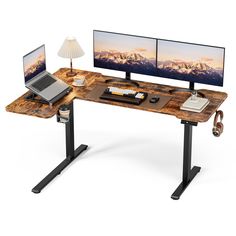 a computer desk with two monitors and a laptop