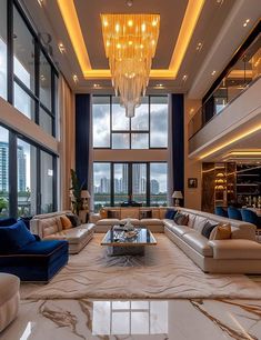 a living room filled with lots of furniture next to tall windows and a chandelier hanging from the ceiling