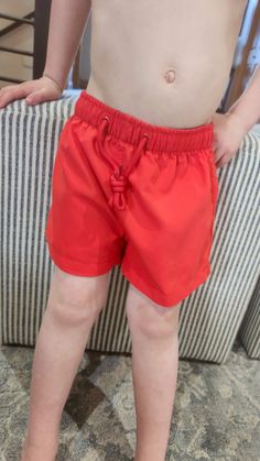 A fully-lined boys swim trunks that are a solid red color. The Fit: true to size 2/3 4/5 6/7 8/9 Laundry: wash normally on cold Model wearing size 2/3 Red Swim Trunks For Beach Season, Red Swim Trunks For Beachwear, Summer Style Red Swim Trunks For Poolside, Red Summer Swim Trunks For Poolside, Summer Red Swim Trunks For Poolside, Red Beachwear Swim Trunks For Swimming, Red Short Swimwear For The Pool, Red Short Swimwear For Pool, Summer Style Short Swim Trunks For Play