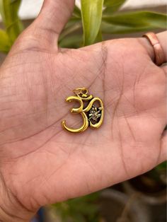 The Om pendant holds significant spiritual and cultural importance in Hinduism, Buddhism, Jainism, and other Dharmic religions. Here are some potential benefits associated with wearing an Om pendant: Spiritual Connection: The Om symbol represents the essence of the universe, encompassing the past, present, and future. Wearing an Om pendant can help deepen one's spiritual connection and serve as a constant reminder of the divine presence within and around us. Peace and Harmony: Chanting or medita Personalized Spiritual Pendant Charm Necklace, Spiritual Good Luck Engraved Charm Necklace, Spiritual Engraved Charm Necklace For Good Luck, Gold Spiritual Charms And Jewelry, Spiritual Bronze Jewelry With Charms, Gold Spiritual Locket Jewelry And Charms, Symbolic Engraved Necklace For Festivals, Meditation Amulet Charm Necklace With Round Pendant, Spiritual Charm Necklace With Round Locket Pendant