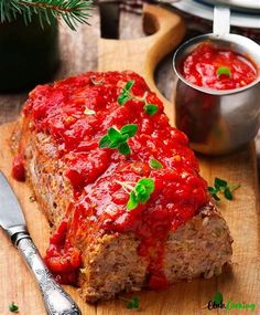 meatloaf with marinara sauce on a cutting board