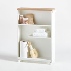 a white shelf with towels, toiletries and other items on it in front of a white background