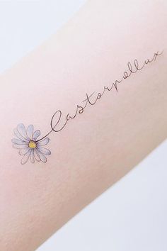 a person with a tattoo on their arm that says estternellas and has a flower in it