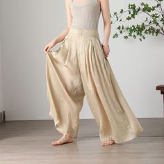 "Cool and comfortable for hot summer days, this apricot wide leg pants is elegant and stylish.    It is a wonderful wardrobe staple that's a timeless classic you'll wear again and again.  All our items are Tailored and Handmade and Made to Order ,I can make Any Size . I design new styles every week, please collect my store. I believe that you will meet your favorite styles. ★★FEATURES Tencel flax Has lining Two side pockets Front zipper closure Wide leg pants Apricot pants Casual pants Long pant Bohemian Summer Pants In Solid Color, Baggy Summer Vacation Bottoms, Spring Summer Harem Pants With Relaxed Fit, Baggy Wide Leg Pants For Beach, Baggy Wide Leg Beach Trousers, Baggy High Waist Harem Pants For Vacation, Bohemian Summer Pants, Summer Wide-leg Relaxed Fit Harem Pants, Summer Casual Wide Leg Harem Pants