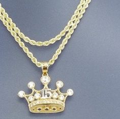 A beautiful crown for the princess that turns 15, all in 14k gold With a 20 inch and 2mm thick, rope style necklace in 14k gold for just $489.00! Pendant is 15mm in height and 20mm width, with zirconia synthetic stones. Gift box is included. Una hermosa corona para la princesa que cumpla sus 15 años en oro de 14k Con una cadena estilos torzal de 20 pulgadas y 2mm de gruesa, en oro de 14k por tan solo $489.00! El pendiente esta 15mm de alto y 20mm de ancho, con piedras zirconia seteticas . Caja d Luxury Gold-plated Rope Chain Jewelry, Elegant Rope Chain Jewelry For Anniversary, Yellow Gold Rope Chain Jewelry For Anniversary, Gold Birthday Jewelry With Crown Design, Gold Jewelry With Crown Design For Birthday, Adjustable Crown Design Jewelry For Anniversary, Luxury Yellow Gold Crown-shaped Jewelry, Luxury Yellow Gold Crown Jewelry, Luxury Rope Chain Pendant Jewelry