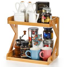 a wooden shelf with cups and coffee mugs on it's bottom rack,