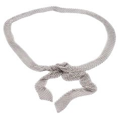 Tiffany & Co. Mesh Tie Scarf / Necklace from the Elsa Peretti Collection finely crafted in sterling silver with a woven mesh chain link design throughout , measuring 49" long and weighs 141.4 grams total, the scarf measures 1" wide approximately. Fully hallmarked. This neckpiece can be worn as a scarf, tie or belt. This is a discontinued model. Necklace Specifications Brand: Tiffany & Co. Style: Elsa Peretti Hallmarks: © Tiffany & Co. STERLING PERETTI Metal: Sterling Silver Length: 49" Width: 1" Mesh Scarf, Scarf Tie, Silver Tie, Scarf Necklace, Link Design, Tie Scarf, Elsa Peretti, Tiffany And Co, White Satin