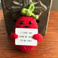 a crocheted red ball with a sign that says i love you from my head to my toes