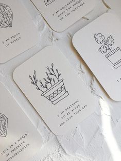 four coasters with plants drawn on them