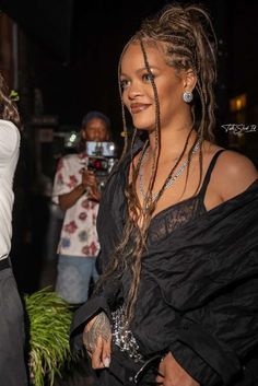 a woman with dreadlocks standing next to another woman