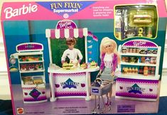 a barbie doll plays with her kitchen set in the box for sale at a toy store