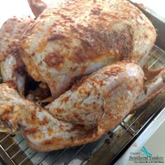 a cooked chicken sitting on top of a metal rack