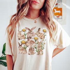 Get ready to fall in LOVE with your new floral, daisy, and rabbit design comfort colors t-shirt. It's the cutest and most comfortable way to wear the latest styles, and also makes a great gift! * PRODUCT DETAILS * ✺ 100% Cotton ✺ Medium weight fabric  ✺ Wash and dry normally (on cool for best results) ✺ Designed and printed in the USA ✺ Due to different monitor screens, colors may vary ✺ * SIZING * ✺ FOR AN OVERSIZED FIT, SELECT TWO OR THREE SIZES UP FROM YOUR NORMAL SIZE ✺ ✺ Sizing is unisex ✺ Casual T-shirt With Bunny Design And Crew Neck, Casual Crew Neck T-shirt With Bunny Design, Casual Cotton T-shirt With Bunny Print, Spring Bunny Print Short Sleeve Tops, Spring Crew Neck Tops With Bunny Design, Bunny Print Short Sleeve Tops For Spring, Spring Bunny Print Tops With Short Sleeves, Short Sleeve Tops With Bunny Print For Spring, Casual Bunny Print Crew Neck Top