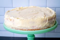 a close up of a cake on a green plate with white tiles in the background