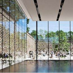 an empty room with glass walls and tiled floor