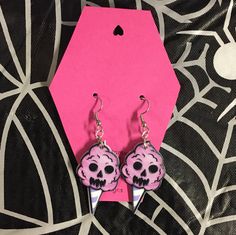 Handmade earrings with double sided charms of a skull cotton candy. Made on stainless steel earring hooks.  Ships within one week of purchase. Free gift on orders over $10, free shipping on orders over $35, and two free gifts on orders over $50! Pink Dangle Jewelry For Halloween, Pink Skull Jewelry For Halloween, Pink Halloween Party Earrings, Pink Punk Halloween Jewelry, Quirky Pink Earrings, Candy Earrings, Ghost Earrings, Skull Face, Pink Cotton Candy