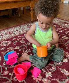 a young child playing with toys on the floor