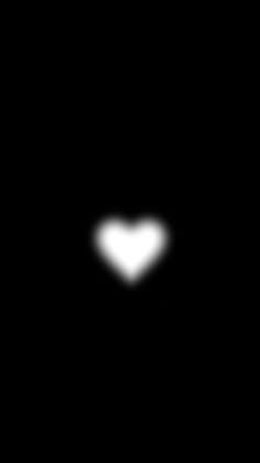 a heart shaped object is seen in the dark night sky with only one light visible