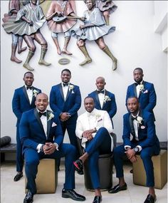 a group of men in suits posing for a photo