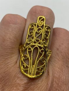 Huge Hand of Fatima for protection Lovely polished brass has the look of antique gold Size 7.75 All rings are shipped in a nice gift box. Check out our over a THOUSAND great reviews Engraving is $4 per letter and is not always perfect depending on the piece. It can take a few days if the jeweler is busy. This is payable to Paypal Judithsltd@gmail.com Gold-tone Brass Rings For Gifts, Symbolic Gold Rings With Antique Finish, Spiritual Gold Metal Rings, Gold Brass Rings As Gifts, Antique Finish Gold Rings For Anniversary, Gold Rings With Antique Finish For Anniversary, Gold Spiritual Metal Ring Jewelry, Symbolic Gold Rings As Gift, Gold Filigree Open Ring Gift