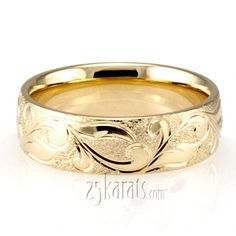 a gold wedding band with an intricate design