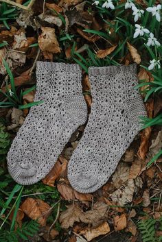 a pair of socks laying on top of leaves