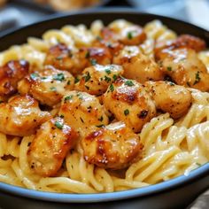 pasta with chicken and parmesan cheese in a bowl