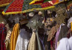 colorful umbrellas and headdresses for sale at an outdoor market