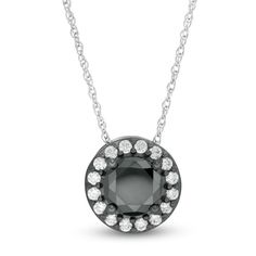 Dramatic color and classic design perfectly combine in this stunning diamond pendant. Crafted in 10K white gold with black rhodium plate, this luxe style showcases a beguiling 2-1/5 ct. enhanced black diamond wrapped in a frame of shimmering white diamonds. Captivating with 2-3/4 cts. t.w. of diamonds and a brilliant buffed luster, this pendant suspends along an 18.0-inch white gold rope chain that secures with a spring-ring clasp. Luxe Style, Diamond Frame, Gold Rope Chains, Peoples Jewellers, Black Necklace, Black Rhodium, White Diamonds, Rope Chain, Diamond Clarity