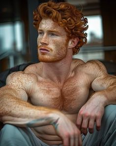 a man with red hair and freckles sitting down