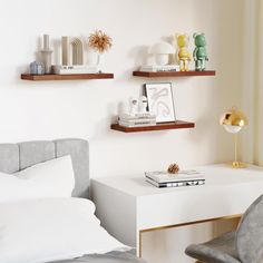 a bedroom with white walls and shelves on the wall