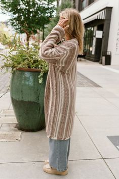 The Alexa Cream & Mocha Stripe Knit Cardigan offers a cozy and stylish layering option. Crafted from taupe and cream stripe knit fabric, this cardigan features a relaxed front opening for easy wear and long sleeves for added warmth. Its neutral tones and timeless design make it a versatile piece, perfect for layering over casual or dressy outfits. Whether you're relaxing at home or heading out, the Alexa cardigan brings comfort and effortless style to any look. Dressy Outfits, Neutral Tones, Striped Knit, Easy Wear, Front Open, Mocha, Effortless Style, Knit Cardigan, Timeless Design