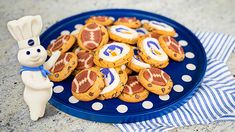 a blue plate topped with cookies covered in frosting