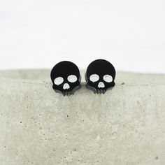 "Glossy black small skull acrylic studs with 0.7mm ear stems. The Studs have a stem length of around 0.4\" (10mm) The skulls measure 0.38\" (9.8mm) (1cm) from top to bottom 0.34\" (8.6mm) (0.9cm) from side to side Laser cut, Lightweight, comfortable and suitable for all occasions.  Each pair is unique and slight variations and imperfections should be expected. 0.7mm Titanium wire. Suitable for even sensitive ears. Grade 1 titanium backs included. Each order comes wrapped in tissue paper. Why not Small Skull, Black Acrylic, Black Acrylics, Hypoallergenic Earrings, Delicate Earrings, Sensitive Ears, Ear Wire, Grade 1, Jewelry Earrings Studs